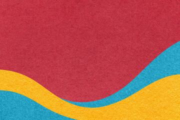 Fototapeta premium Textured red paper background with turquoise and yellow wavy lines and waves, copy space for banner, presentation