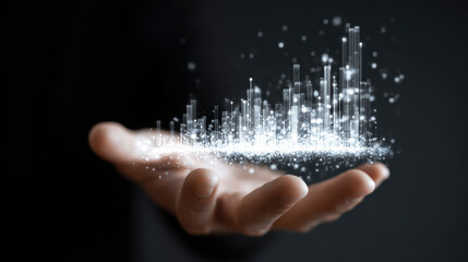 Hand holds glowing, abstract representation of data visualization, featuring bars and sparkles that symbolize growth and analytics. This conveys innovation and technology