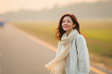 woman stands at gate gazing into distance with anticipation and hope