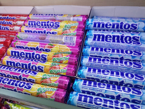 Variety of mentos flavors in colorful packaging on display shelf