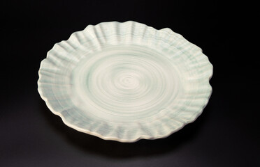 Beautiful plate, beautiful plate alone placed on a dark background, selective focus.