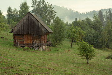 old wooden building on a mountainside in the morning