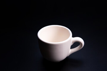Cup, beautiful cup alone placed on a dark background, selective focus.