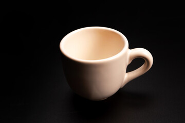 Cup, beautiful cup alone placed on a dark background, selective focus.