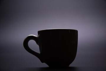 Cup, beautiful cup alone placed on a dark background, selective focus.