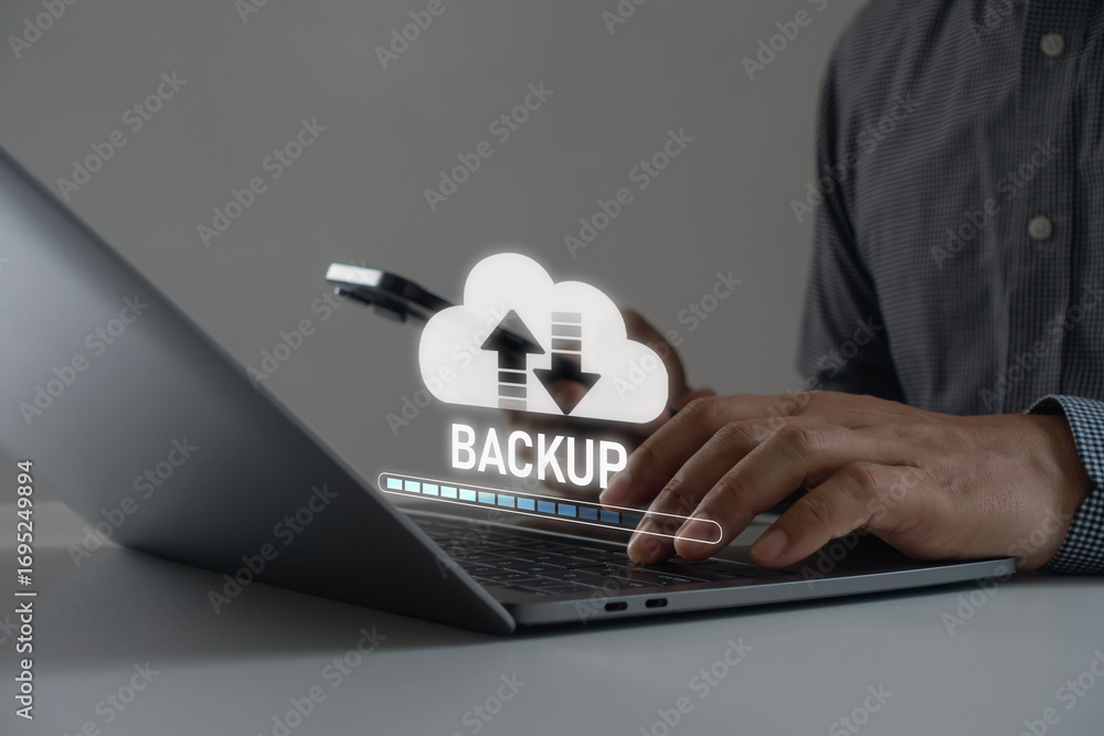Poster businessman using laptop with hologram cloud backup icon, showing data upload and download process, 