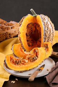 Cut Musquee De Maroc Pumpkin With Orange Flesh On Kitchen Table