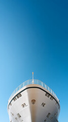 Majestic cruise ship viewed from dock against clear blue sky for travel inspiration