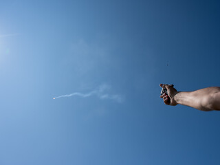 A man fires a flare gun with emergency fire. Close-up of a man's hand. 