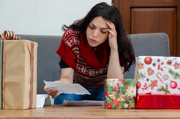 Young concern woman looking a bill after buying presents and gifts