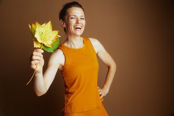 Joyful Woman Embracing Autumn Leaves