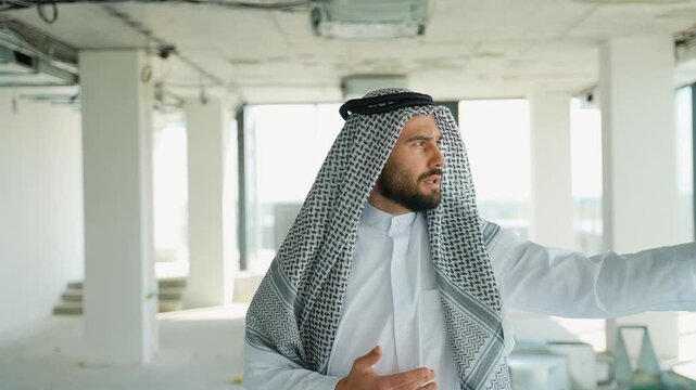 Arab businessman presenting in unfinished office space