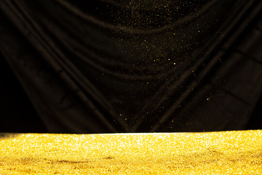 Fototapeta Photo of golden glitter powder sand creating abstract bokeh festive atmosphere. Bokeh of particle element of gold glitter sand light up luxury  background, sparkle glow wallpaper