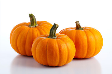 Bright orange pumpkins arranged on a white background