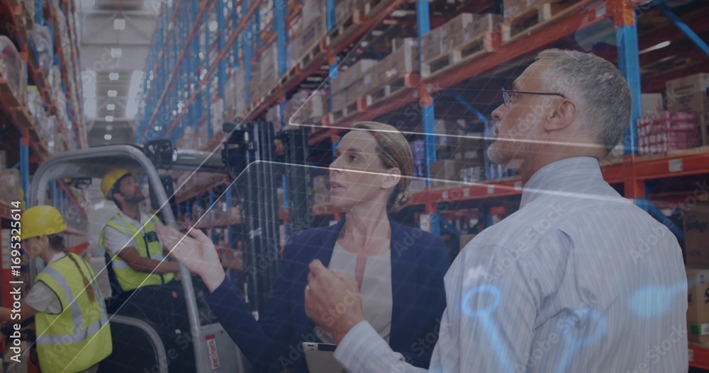 Poster reviewing digital data two supervisors collaborating in warehouse, with tablet and virtual display