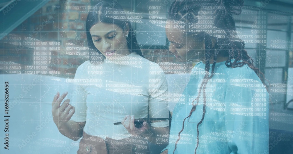 Poster two coworkers in business attire analyzing code overlay on tablet with stylus in open-plan office
