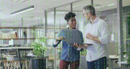 Discussing colleagues wearing casual attire in office with laptop, plants and green binary code