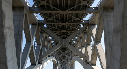Intricate Concrete Bridge Structure with Arches and Steel Beams.