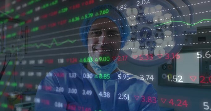 Surgeon wearing blue scrubs posing in OR, showing financial overlay, light and control panel
