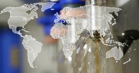 Filling clear glass bottle with amber liquid on bottling line, with nozzle and world map overlay