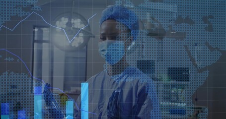 Medical professional wearing surgical gear analyzing data in surgical room with transparent display