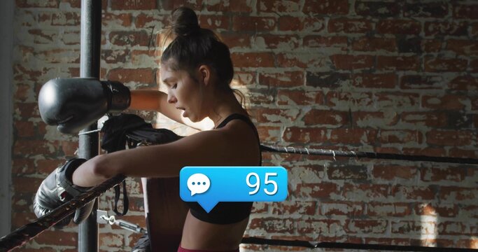 Leaning boxer in sportswear catching breath in ring, with gloves and comment bubble showing 95 - Powered by Adobe