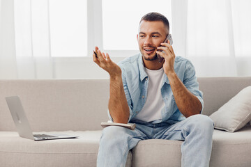 Smiling man on the phone, casual attire, relaxed setting, engaging conversation, modern workspace, natural light enhancing the ambiance.