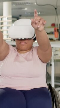 Vertical video: Wheelchair user is lifting VR headset adjusting fit and tapping controls for rehab