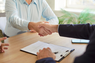 Handshake deal, people get acquainted with real estate agent, meeting together in office, shake...