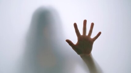 Ethereal figure behind frosted glass, hand reaching out