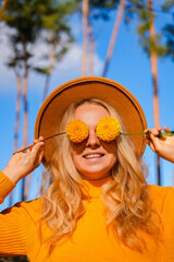 Woman close her eyes with yellow dahlia Autumn garden colorful flowers. Beautiful autumnal bouquet...