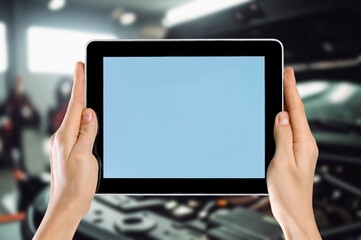 Car technician checking battery with a scanner tools
