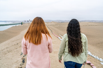 Tourists exploring ancient ruins near desert lagoon