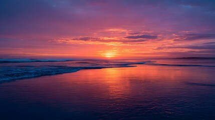 Obraz premium A breathtaking sunset paints the tranquil ocean with vibrant hues of orange, purple, and pink, creating a serene and peaceful ambiance.