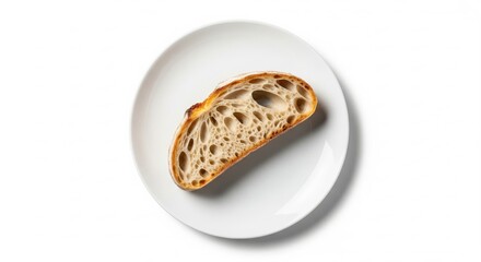 Slice of crusty sourdough bread on a white plate illuminated by natural light, highlighting the airy crumb and golden crust, emphasizing freshness and simplicity .