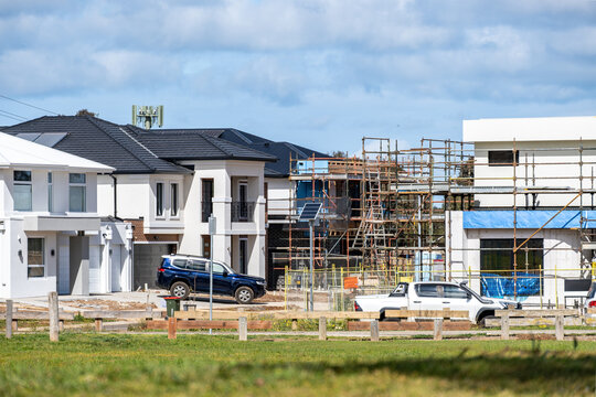 New residential houses under construction in suburban Melbourne, Australia, with modern homes, scaffolding on site. Concept of housing growth, urban expansion, and real estate development.