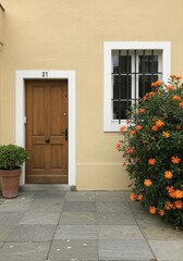 Naklejka premium Mediterranean Building Facade with Orange Flowers