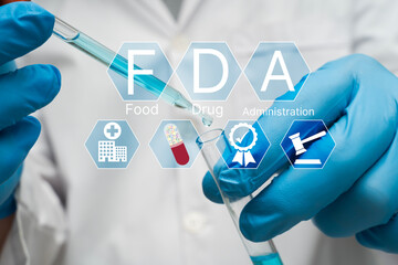 FDA approval concept with scientist in laboratory handling test tube and pipette for drug research safety