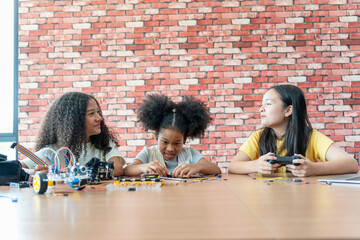 Children Experimenting with Robotics in STEM Education Workshop, Young Student Girls Learning Innovation and Building Robotics Models in Science Class