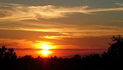Colorful sunset over a silhouetted landscape