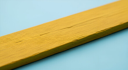 Angled View of a Yellow Painted Wooden Plank with Visible Grain and Imperfections.