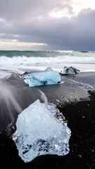 Glacial ice fragments on a black sand beach
