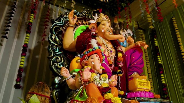 Beautiful, vibrant shot of Ganpati Bappa Mangalmurti inside decorated pandal. Perfect for Ganesh Chaturthi, cultural, religious, festival projects&mdash;HD 4K stock footage.