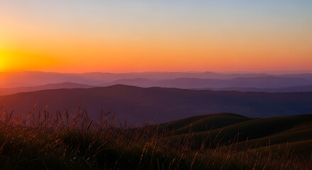 Rolling hills at sunset with golden grass