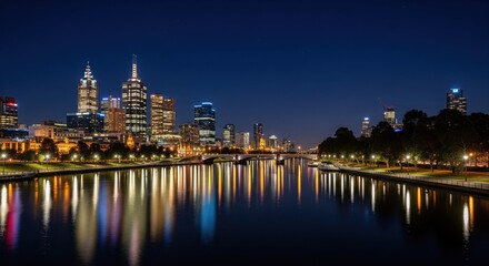 City skyline at night reflected in a river
