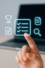 Checklist with digital icons and hand pointing on laptop screen for task management and success