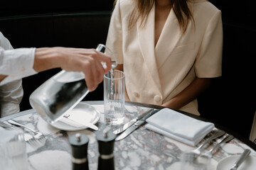 Pouring Water From A Water Jug In Restaurant