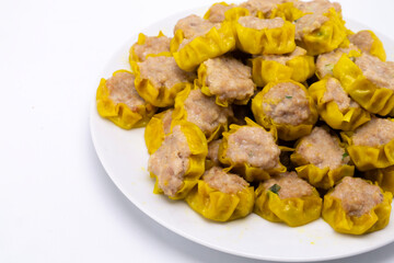 Steaming Hot Siu Mai Dumplings Pile on White Plate, Delicious Asian Cuisine, Close-Up.