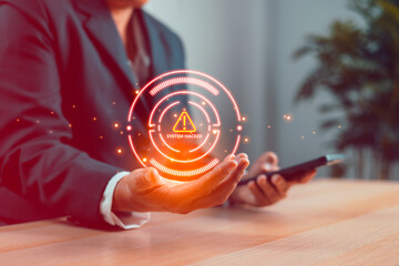 Businessman holding digital hologram with system hacked warning alert, concept of cybersecurity...