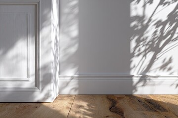 White room corner with sunlight and leaf shadows